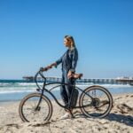 Moeder op fiets op strand